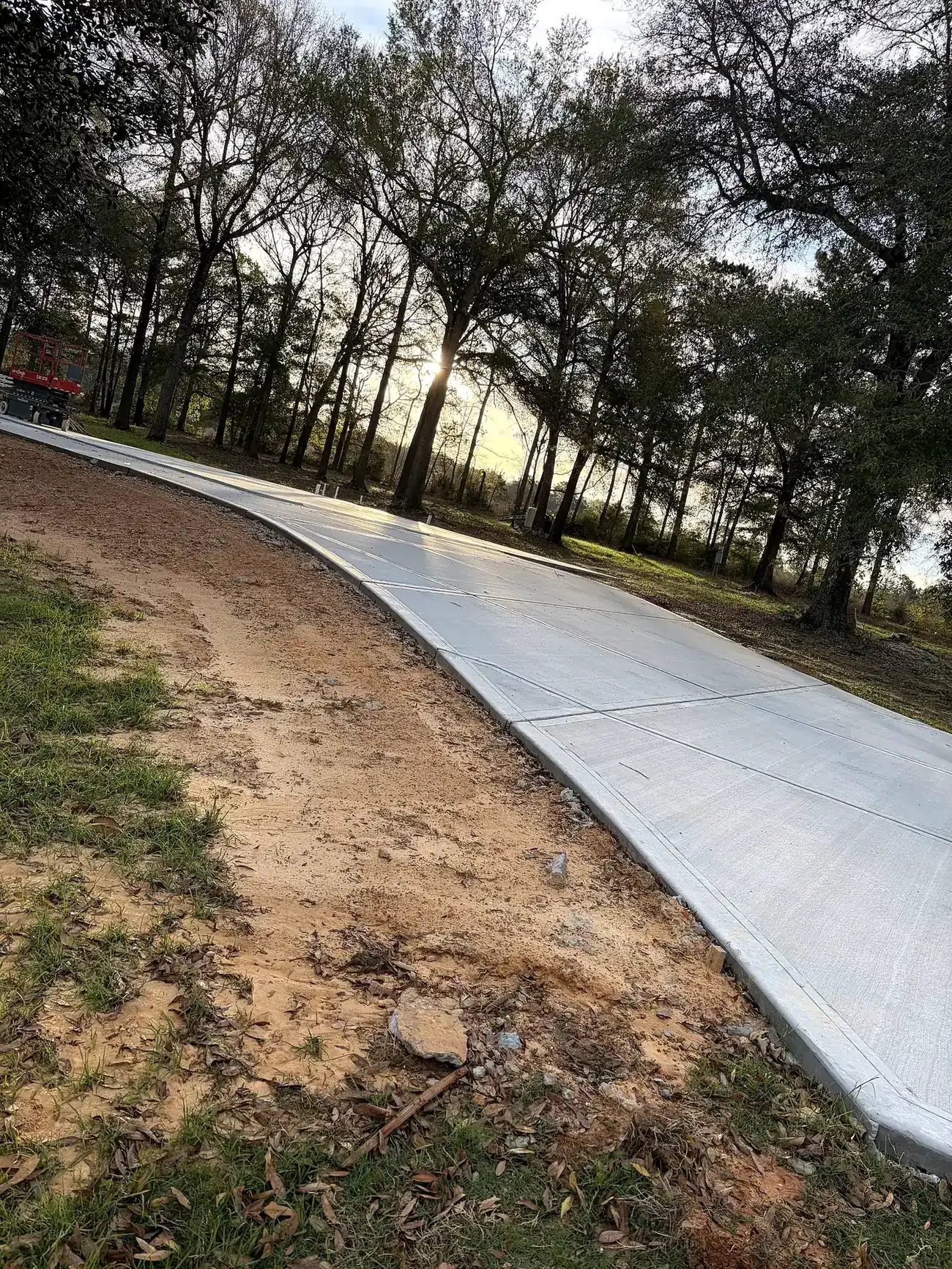 Completed residential concrete driveway extension at golden hour in Willis, TX